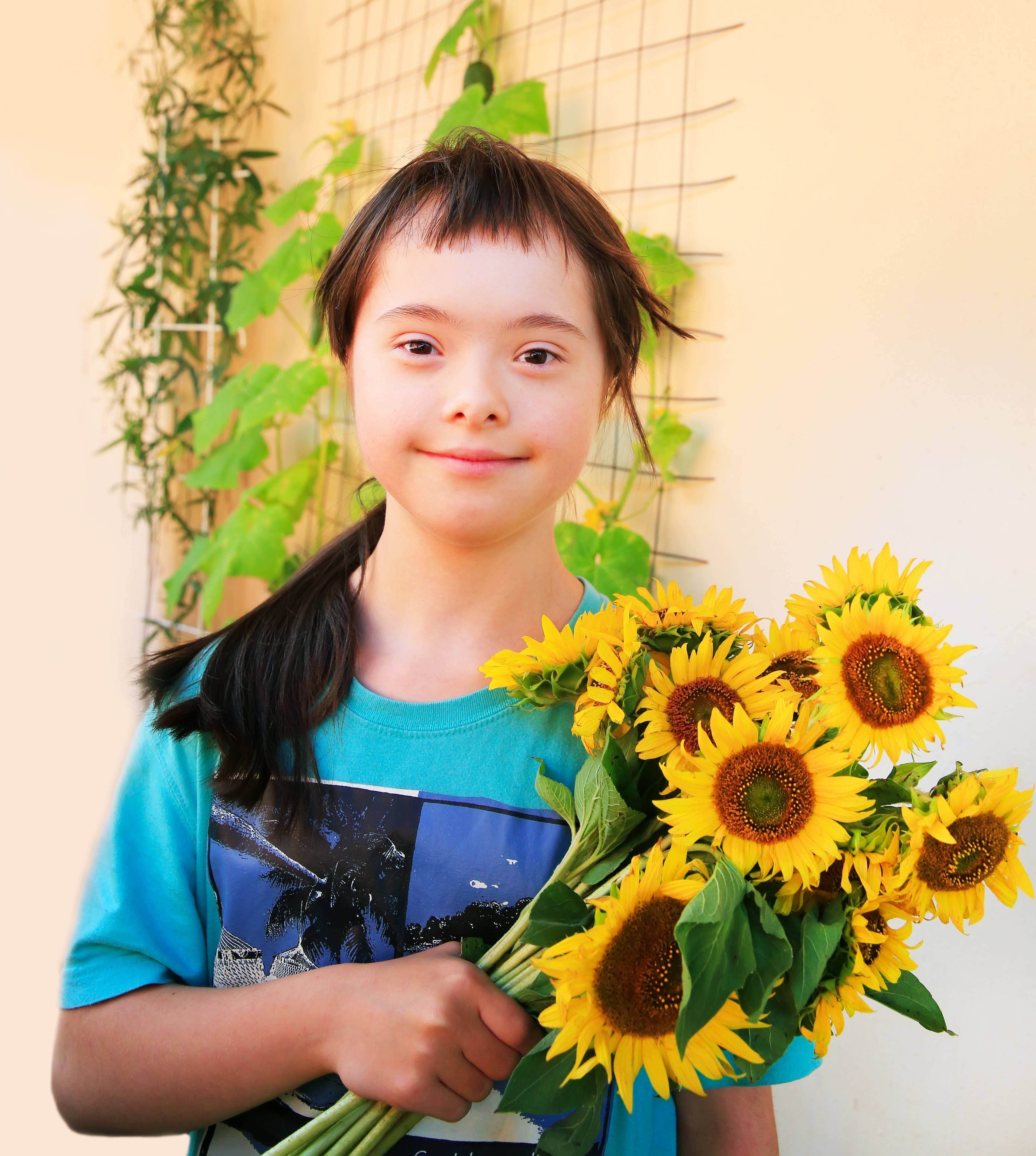 Down syndrome girl with sunflowers